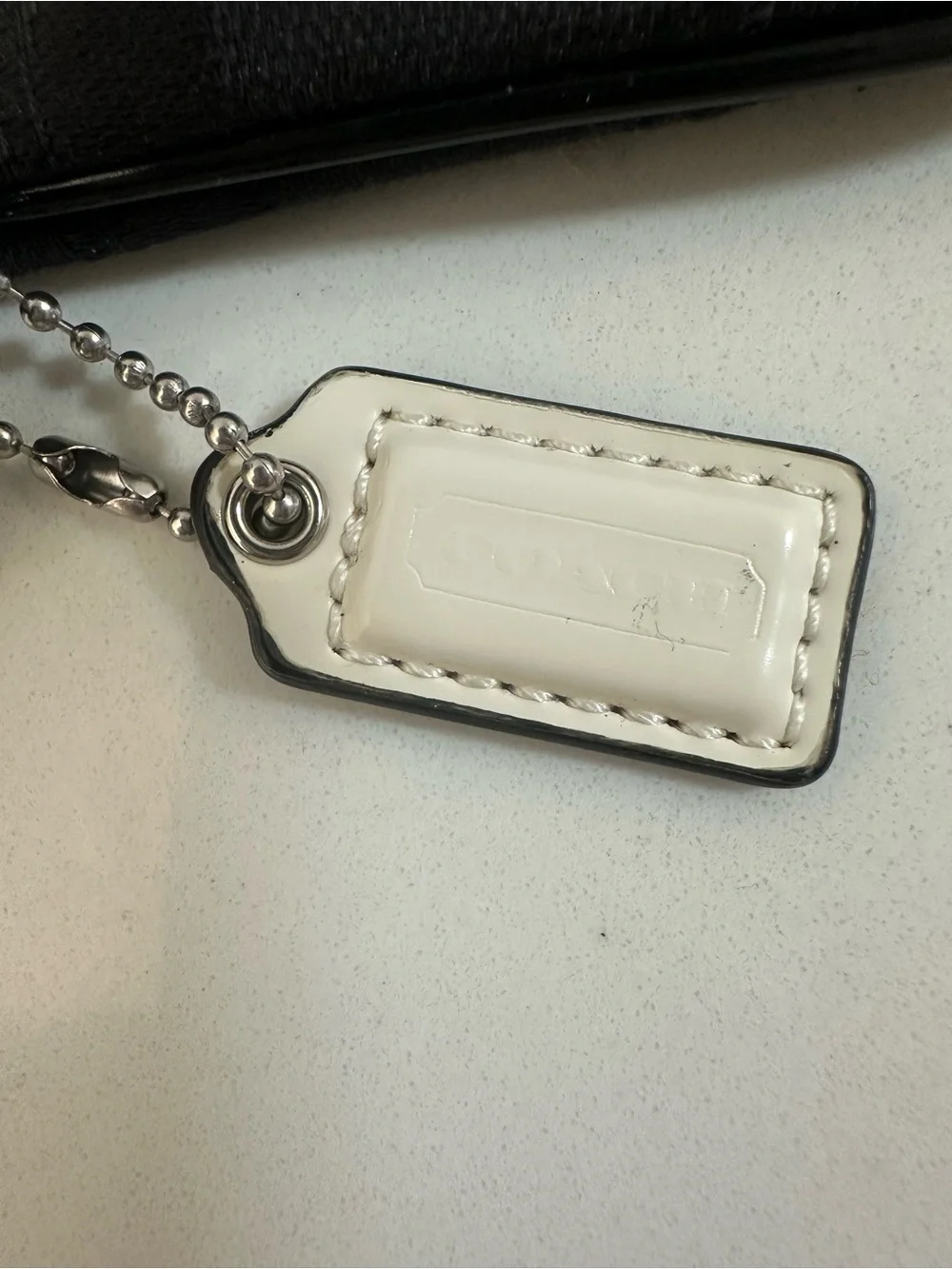 COACH Black Signature Wristlet with white coach tag